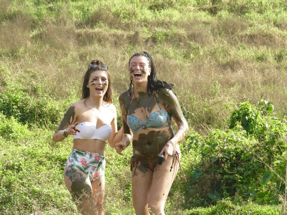 Two women enjoying a mud bath.