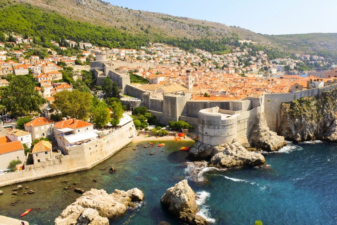 Aerial view of a historic coastal city.
