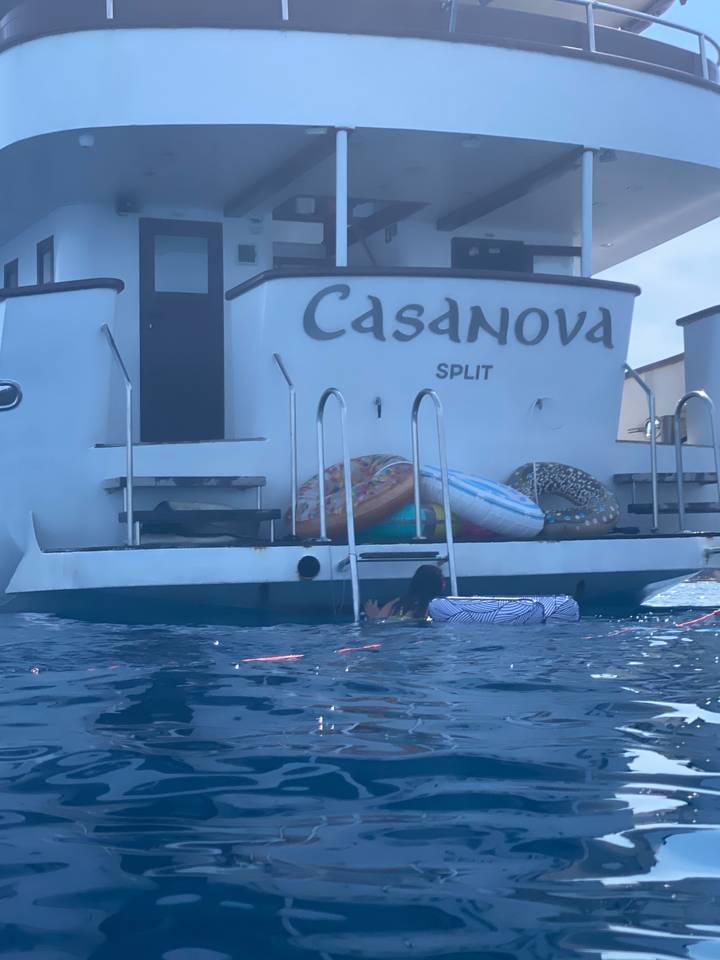 Back view of a boat named Casanova in the water.