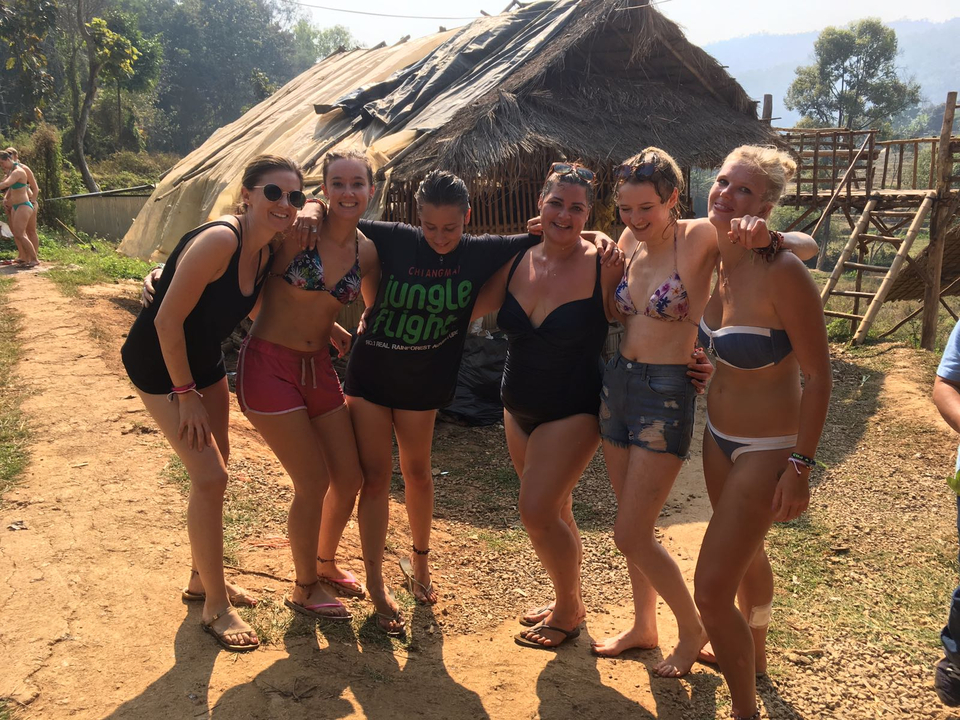 Friends posing together, smiling outdoors.
