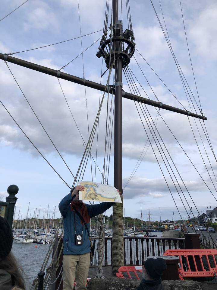 Person holding a map on a boat.