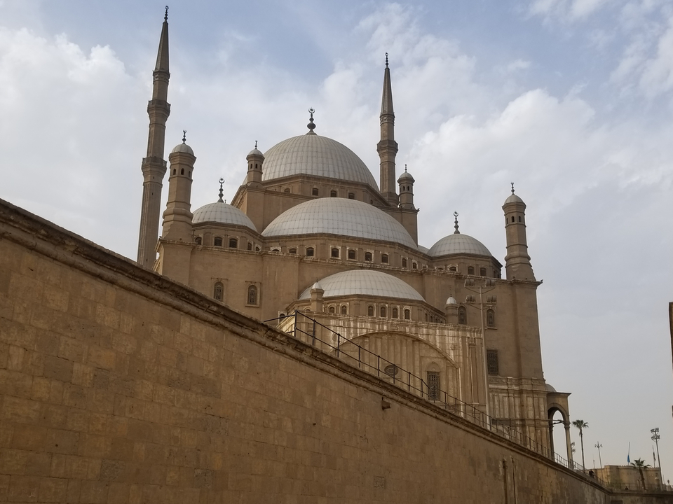 Large mosque with multiple domes and minarets.
