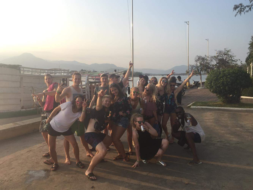 Large group posing happily in outdoor setting.