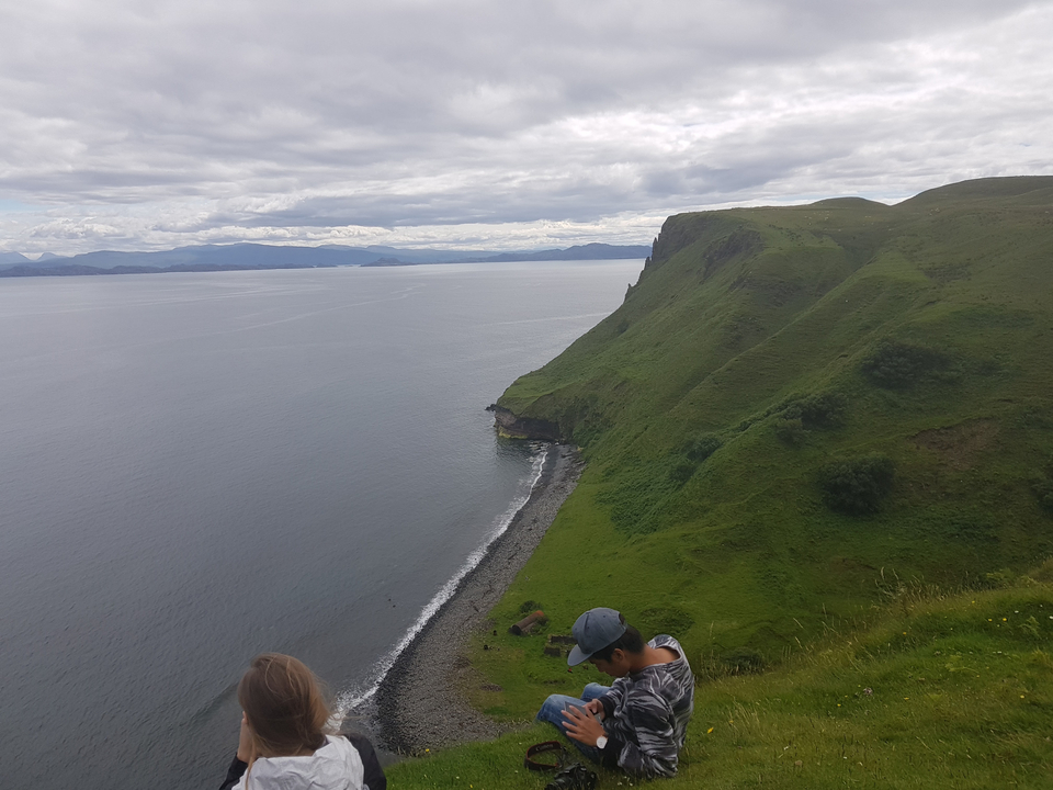 Coastal cliff view with overcast sky.
