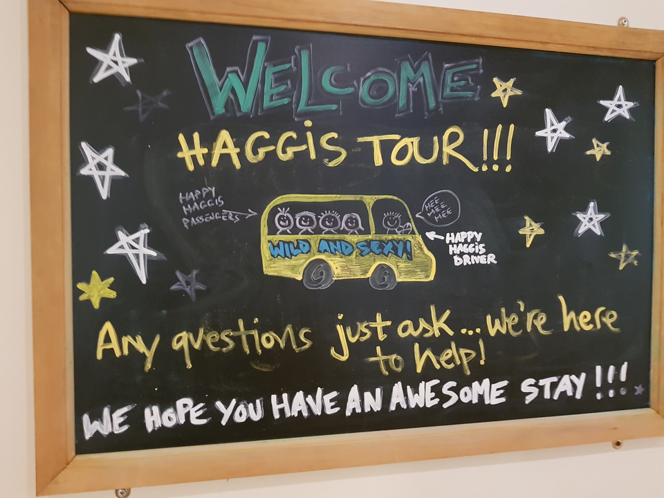 Text on a chalkboard promoting a tour.