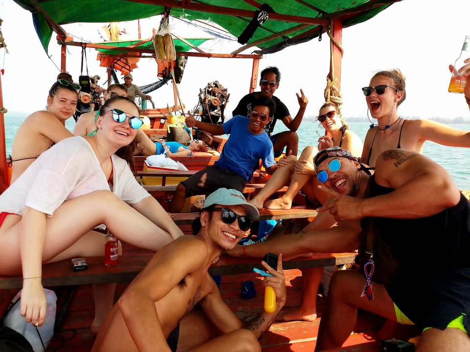 Group of people on a wooden boat having fun.