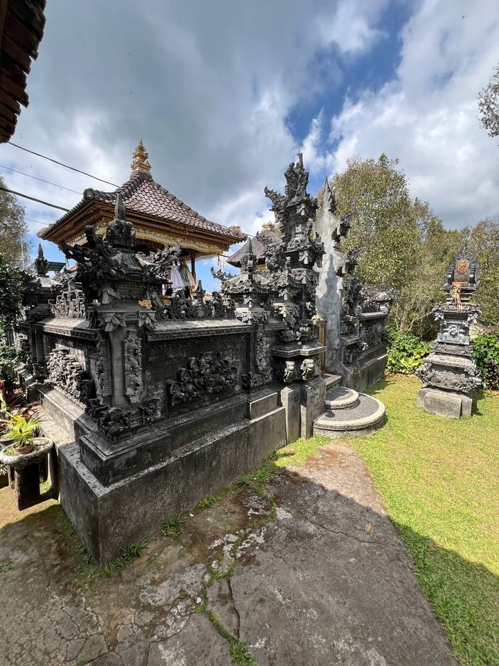 Intricate temple structure with carvings under a blue sky.