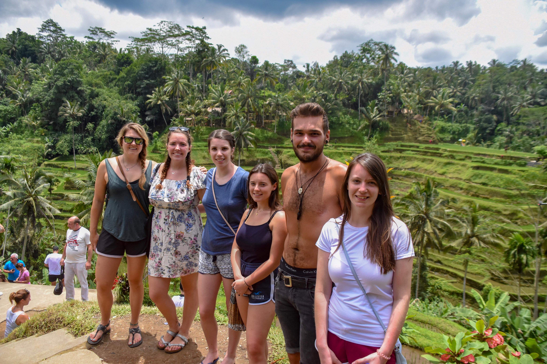 Group photo with a scenic view of rice terraces.