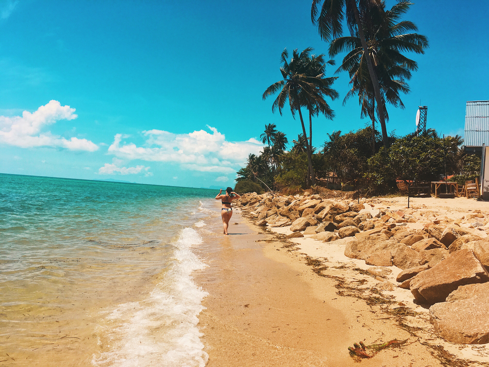 A person jogging along a tropical beach.
