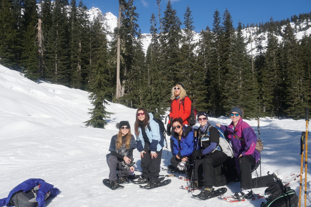 Group of hikers resting in a snowy forest.
