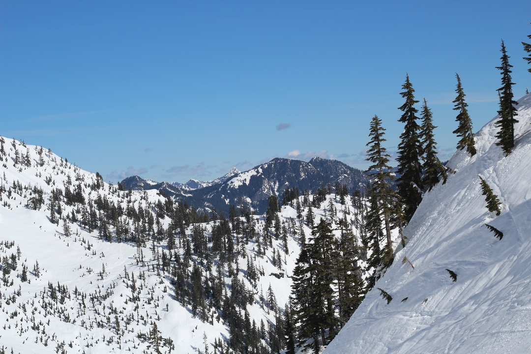 Snowy mountain landscape with clear skies.