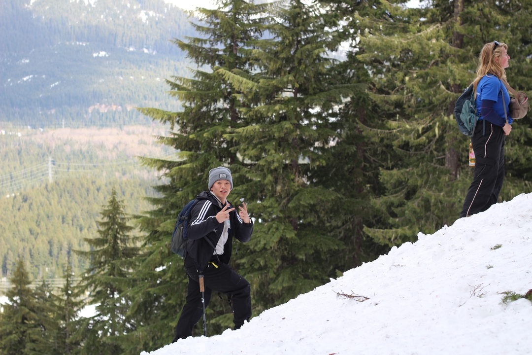 Group of people hiking on a snowy hill.