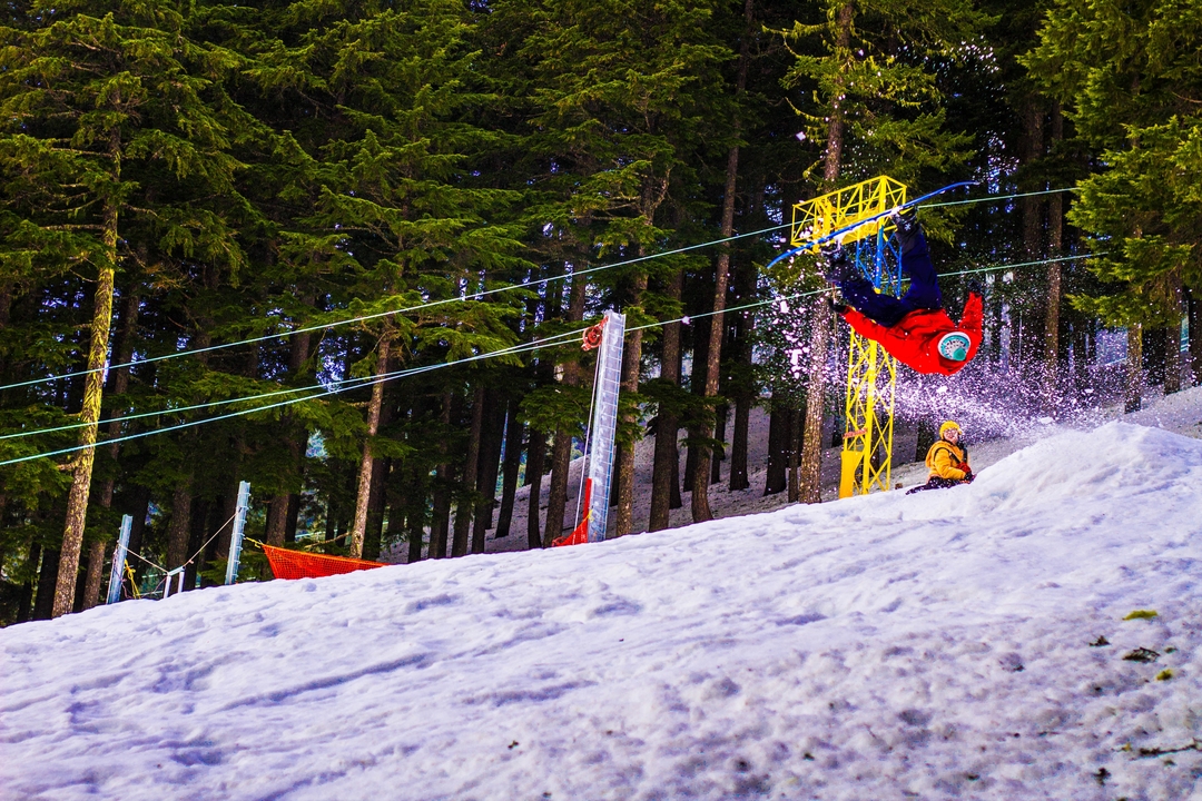 A skier performing a flip in the snow.