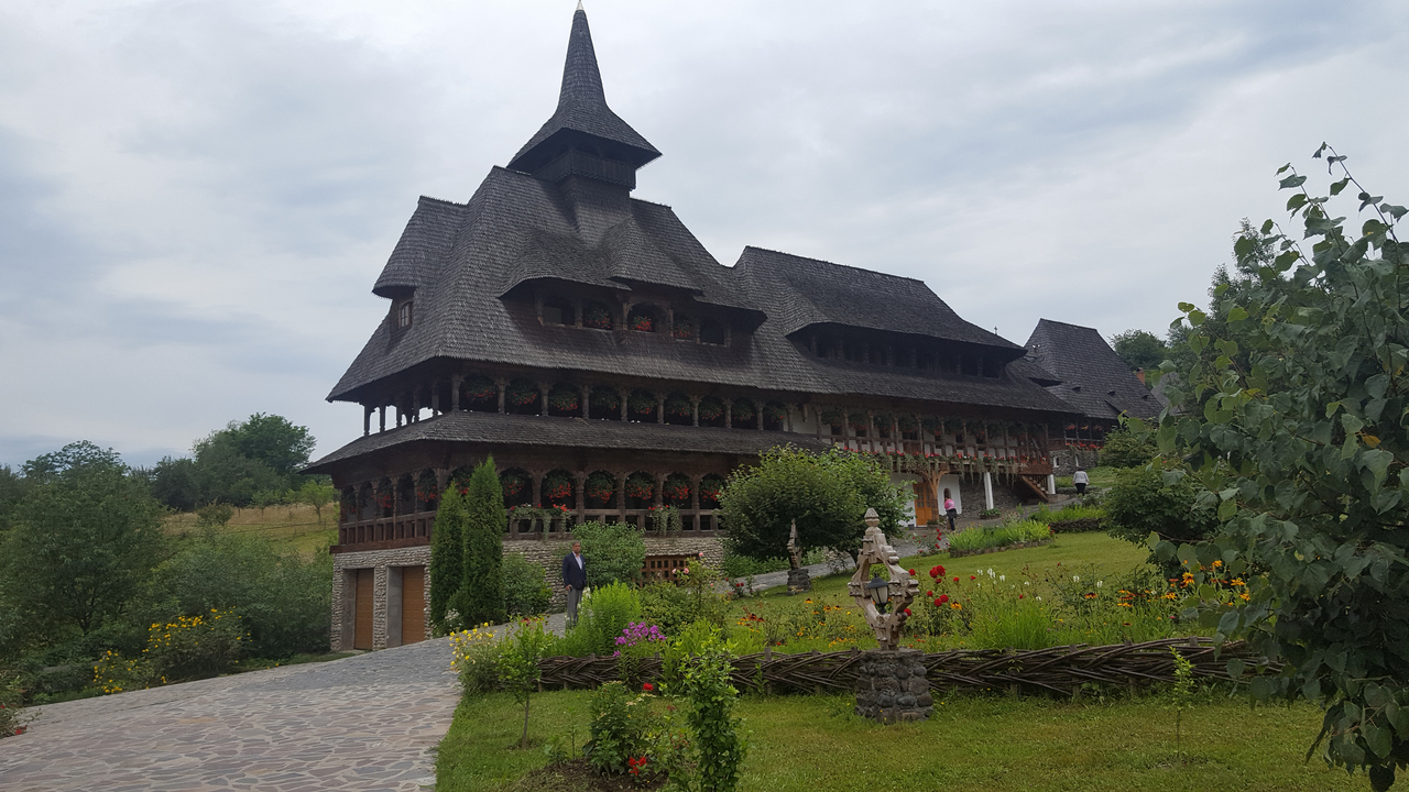 Large wooden building with a garden.