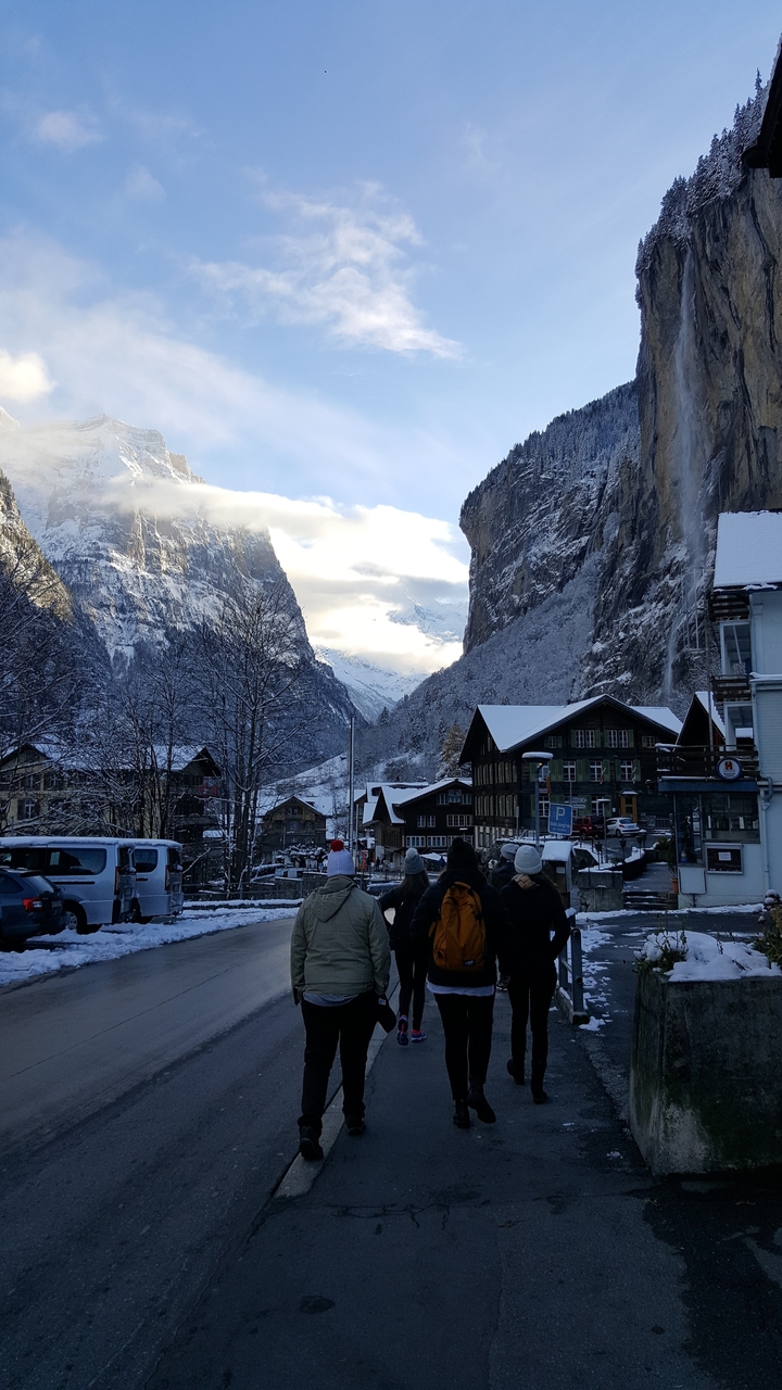 Snow-covered mountain village with wooden cabins.