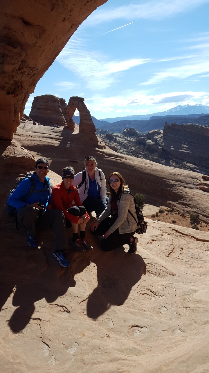 Group of hikers posing in a canyon landscape.