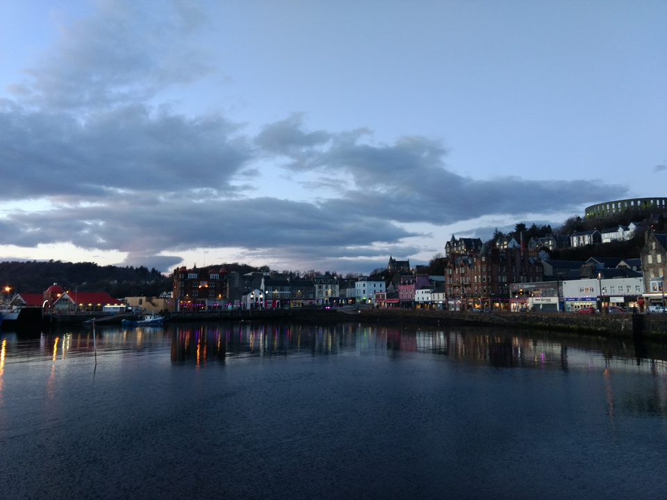 Town buildings along a waterfront at dusk.
