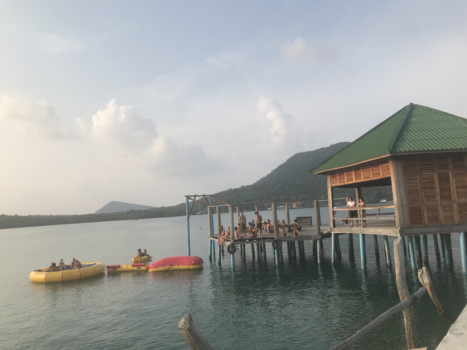Floating bar with people enjoying on inflatable structures.
