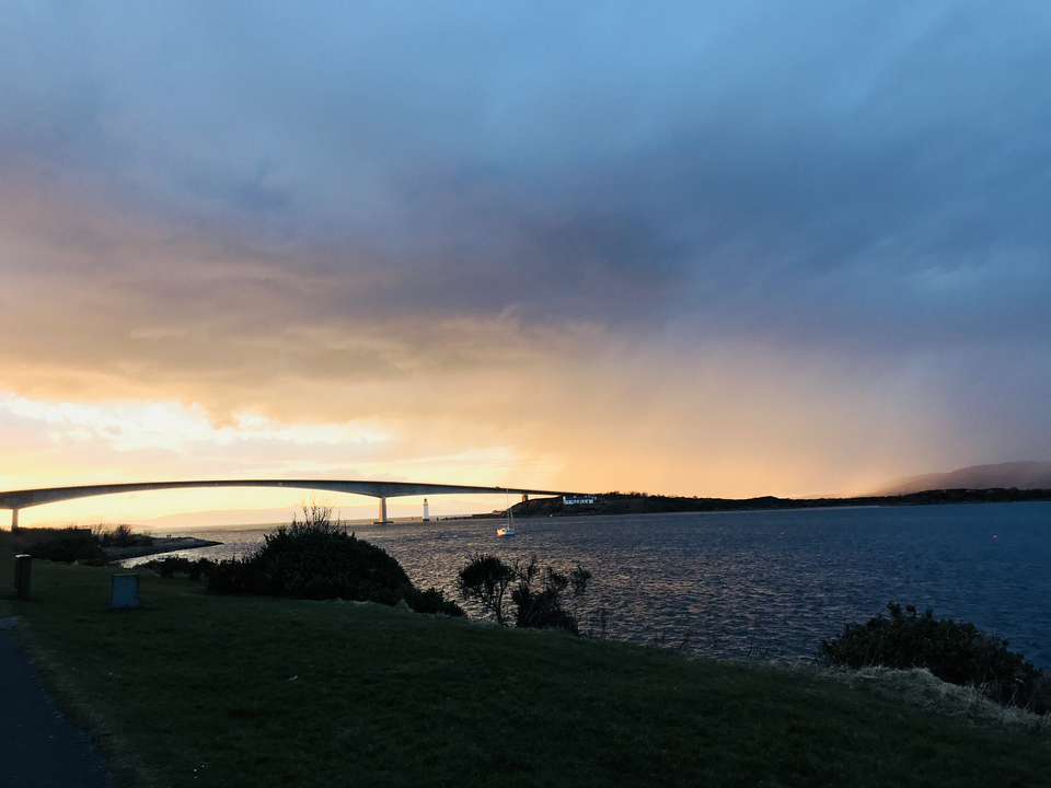 Bridge at sunset with colorful clouds.