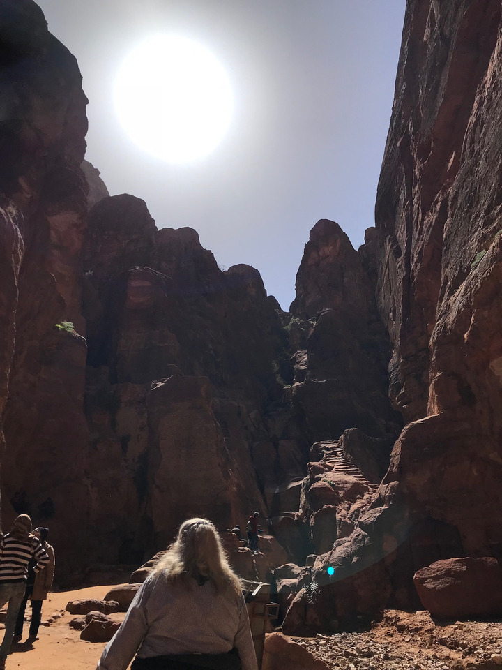 Sunlight shining down a rocky canyon with steps.