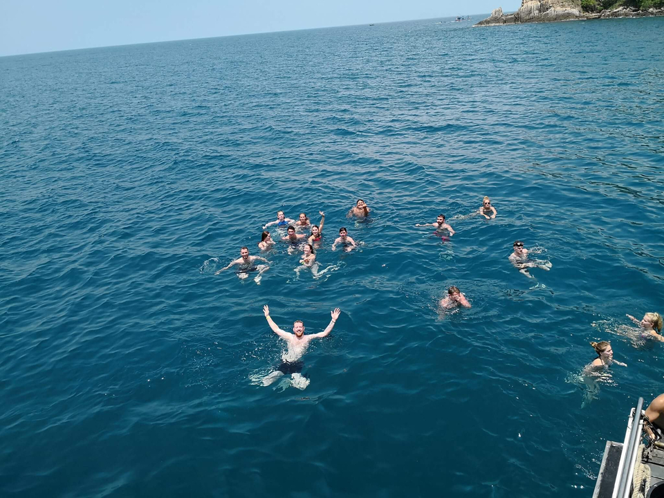 People swimming in the ocean, viewed from above.