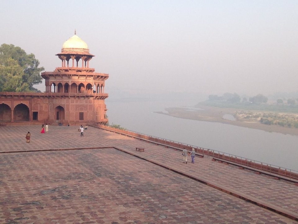 A riverside fort with a distant view of people walking