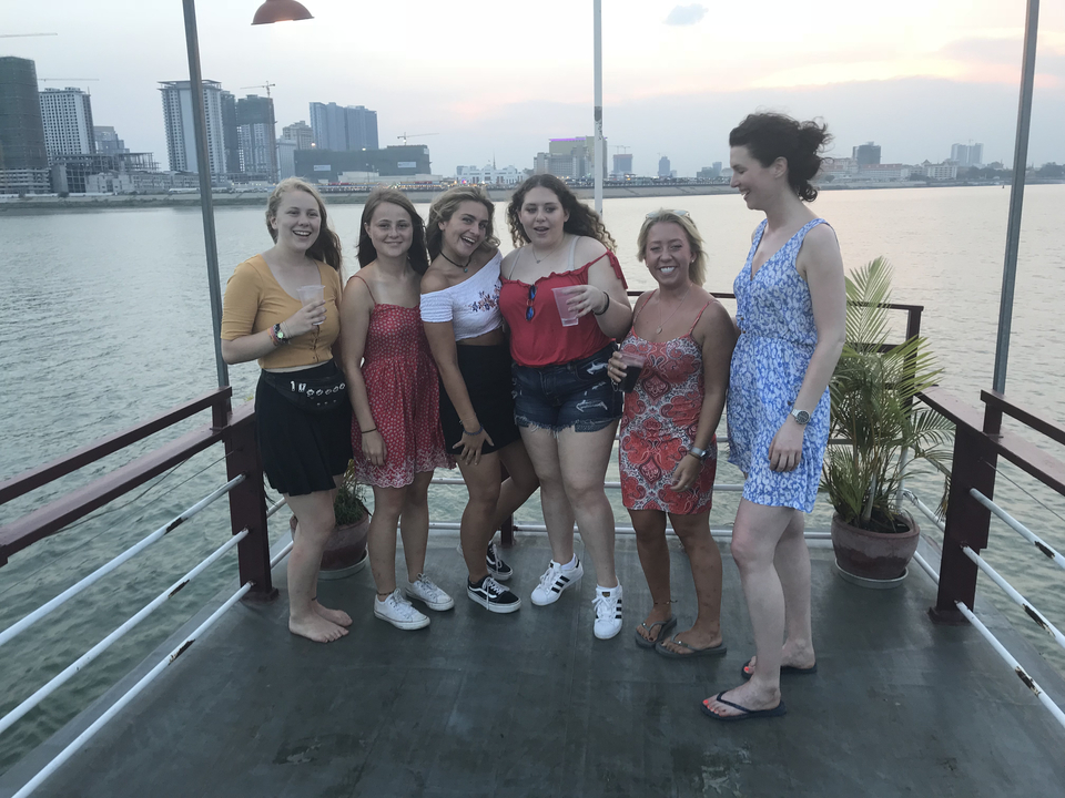Group of people enjoying drinks on a boat.