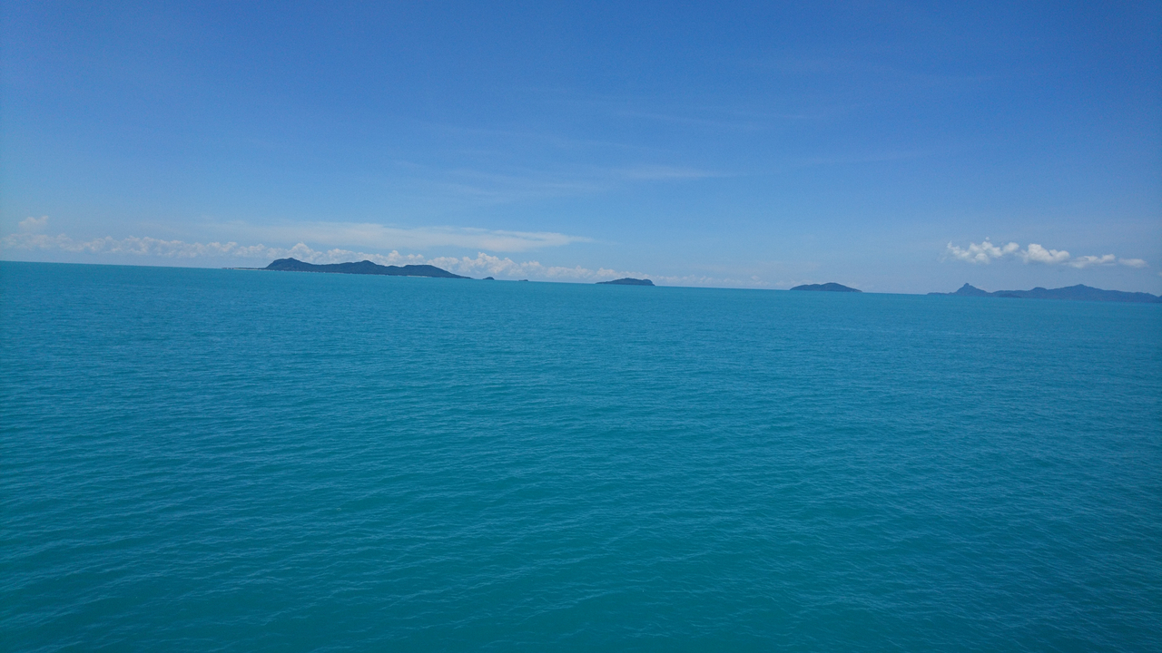 A vast stretch of open sea with islands visible on the horizon.