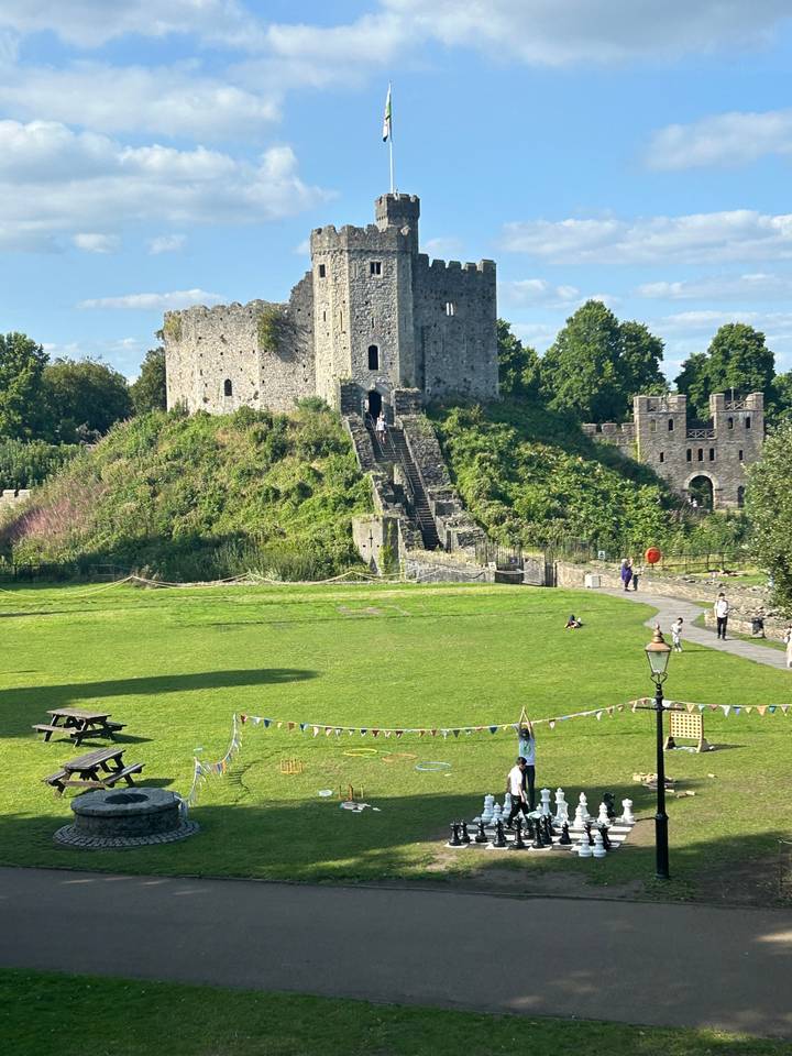 A grassy field with a castle ruin.