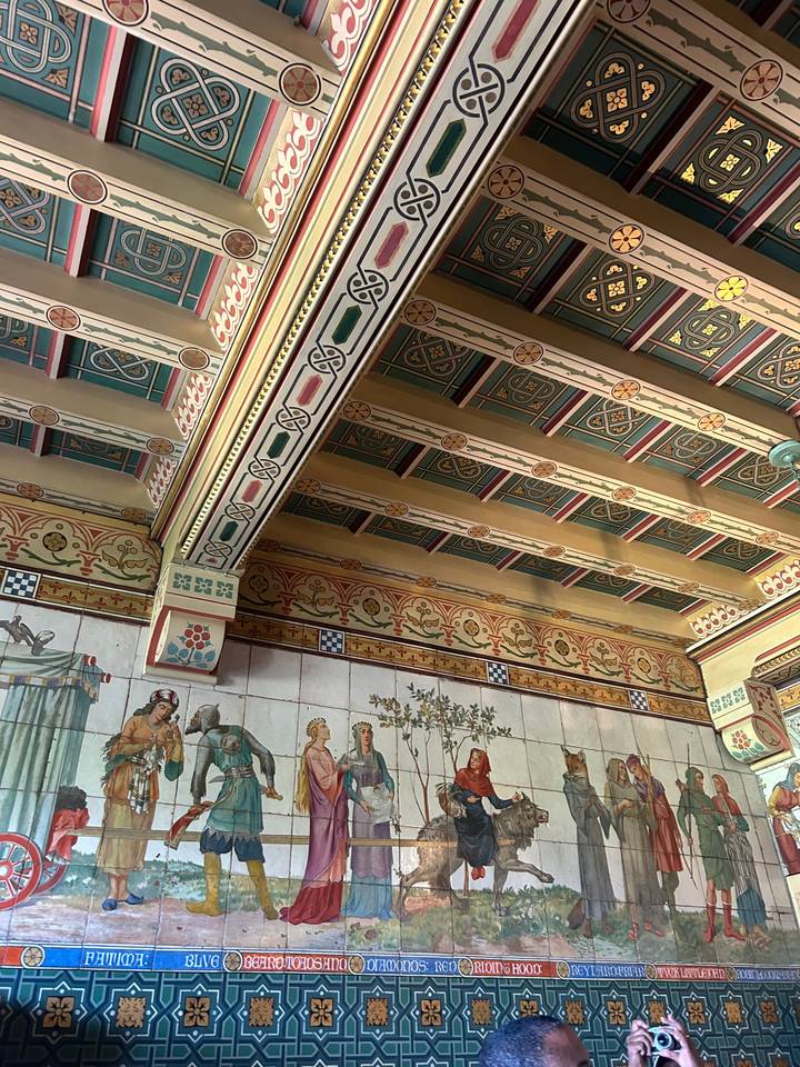 Colorful tiled artwork depicting historical scenes.