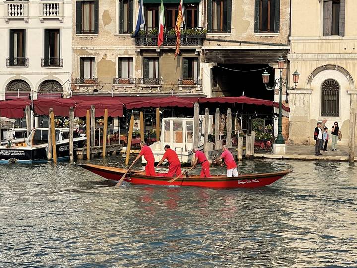 Gondola ride on a canal with people.