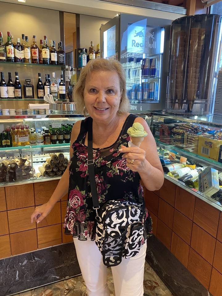 Person enjoying gelato in an indoor setting.