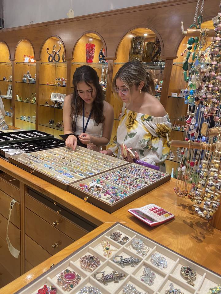 People looking at jewelry in a store.
