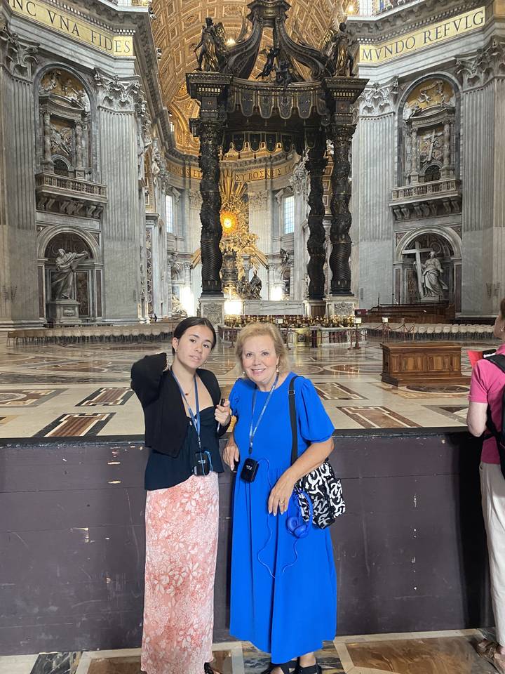 Two people inside a grand cathedral with ornate architecture.