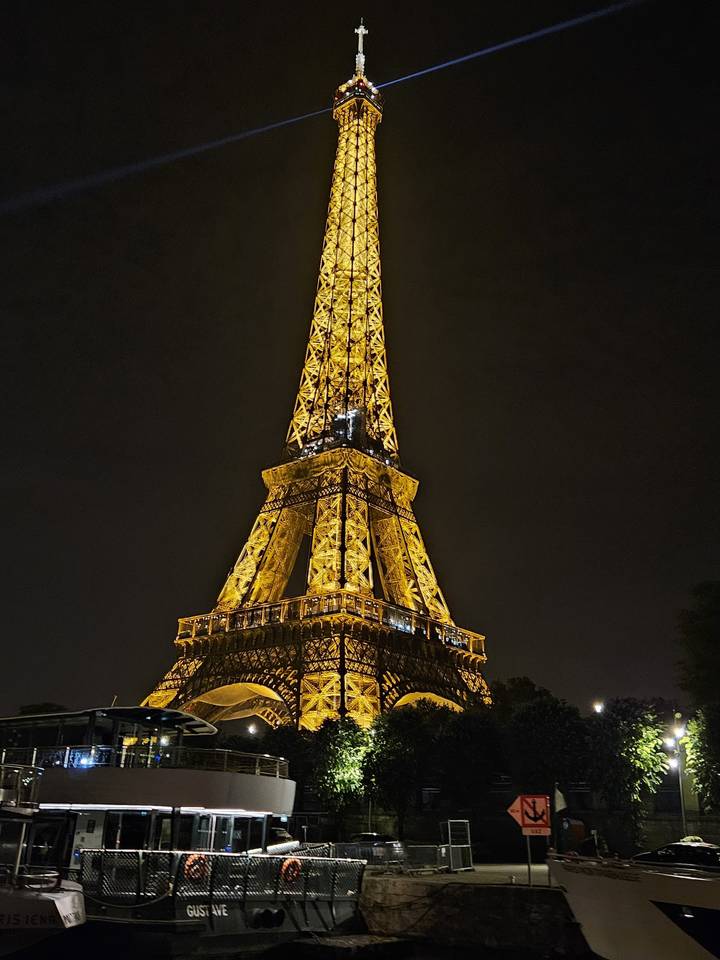 Eiffel Tower illuminated at night.