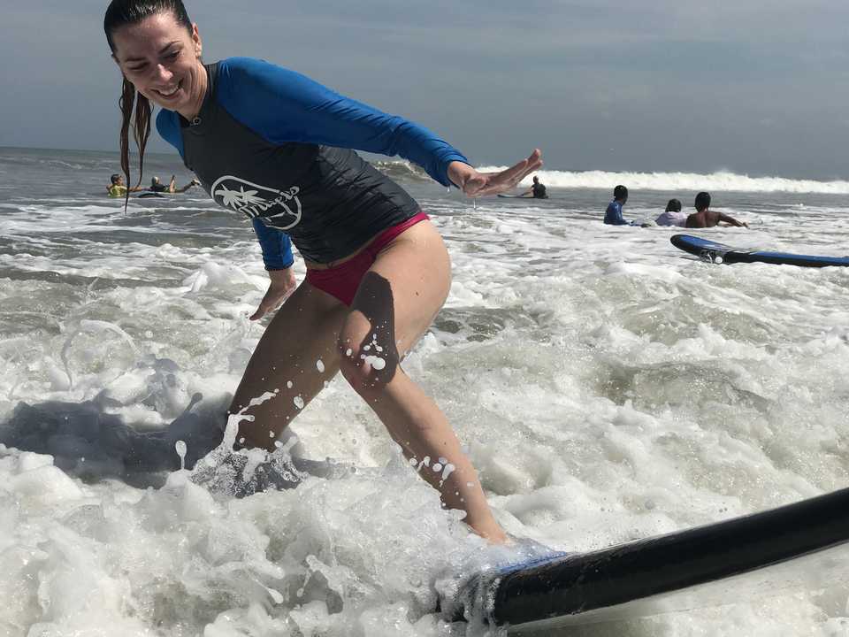 Woman surfing in the ocean waves.