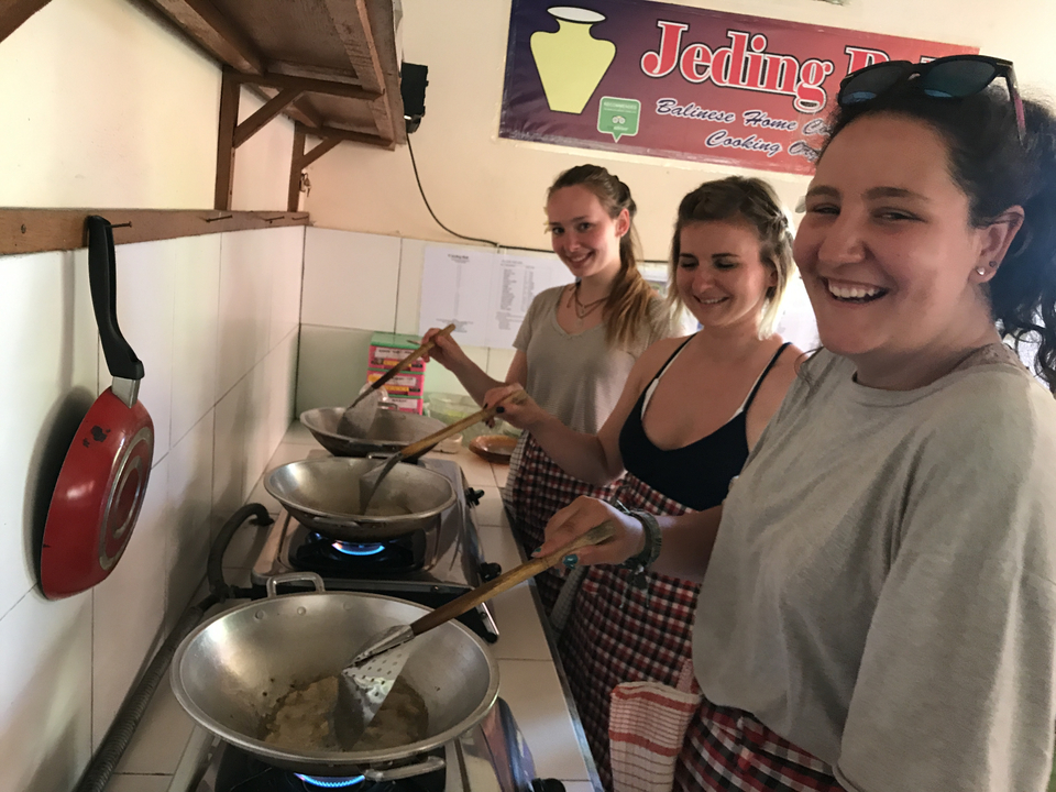 Group cooking together, smiling and having fun.