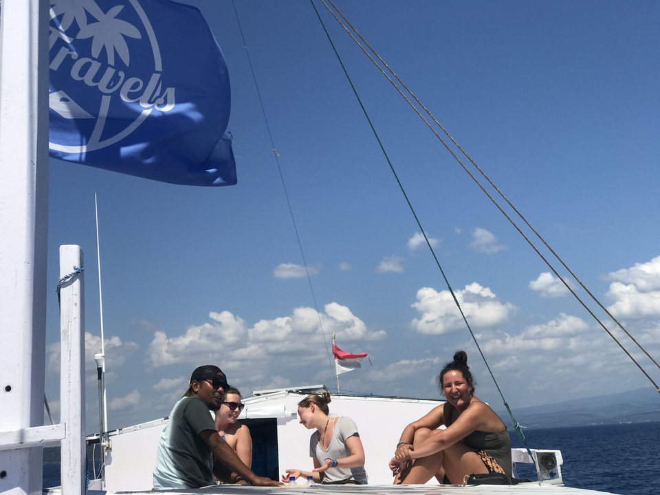 People enjoying a boat ride with flags overhead.