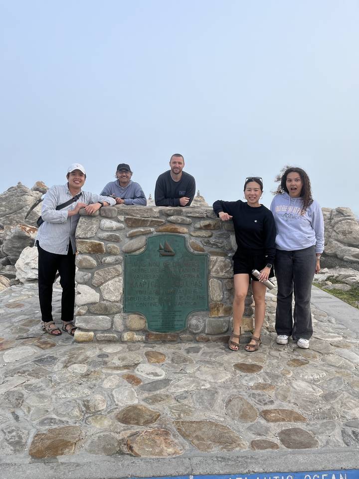 Group photo by a stone monument.