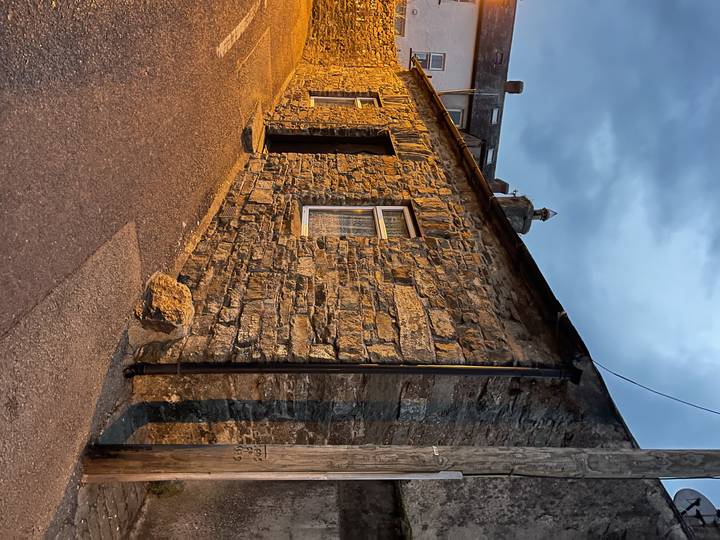 Stone building with a cloudy evening sky.