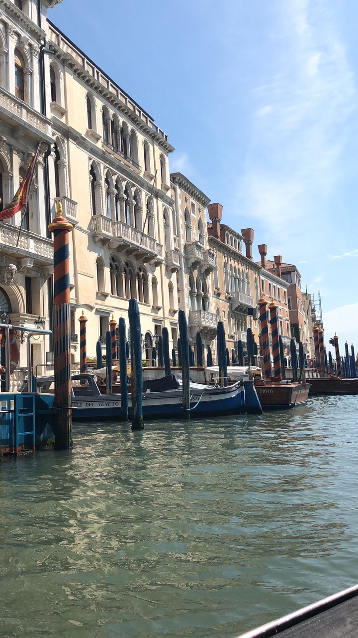 Venetian canal with gondolas and traditional architecture along the water.