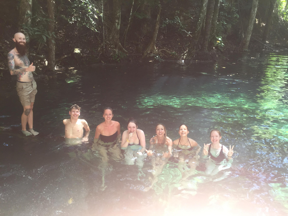 Group enjoying a swim in a natural pool.