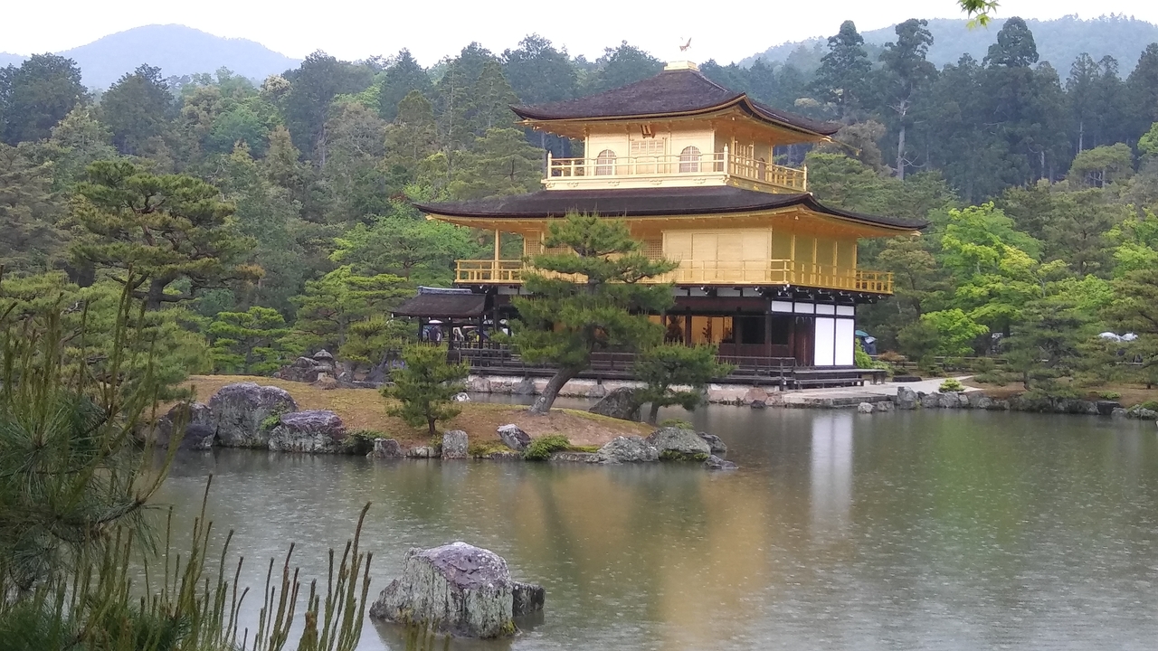 Kinkaku-ji (Golden Pavilion) on a pond surrounded by trees.