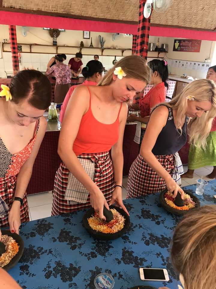 Participants engaged in a cooking class preparing traditional dishes.