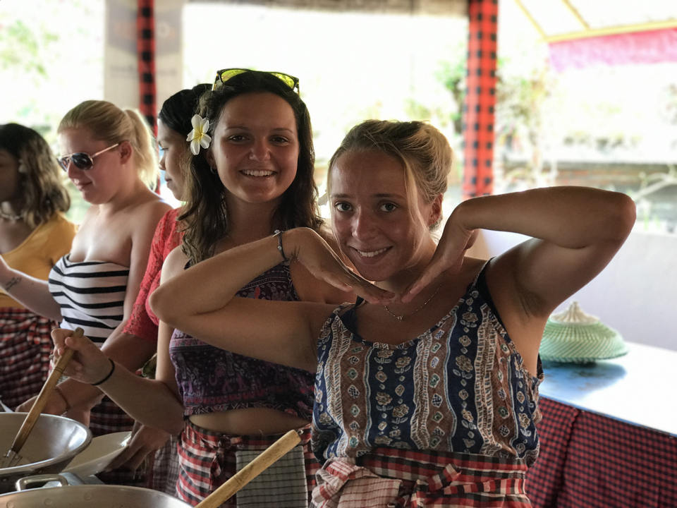 Two women smiling and posing during a group activity.