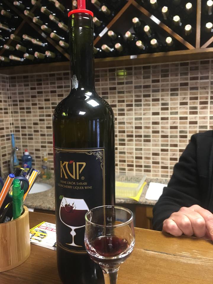 Sideways view of wine tasting with a bottle and glass.