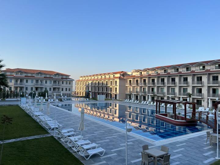 Upside-down image of a large hotel with a pool in front.