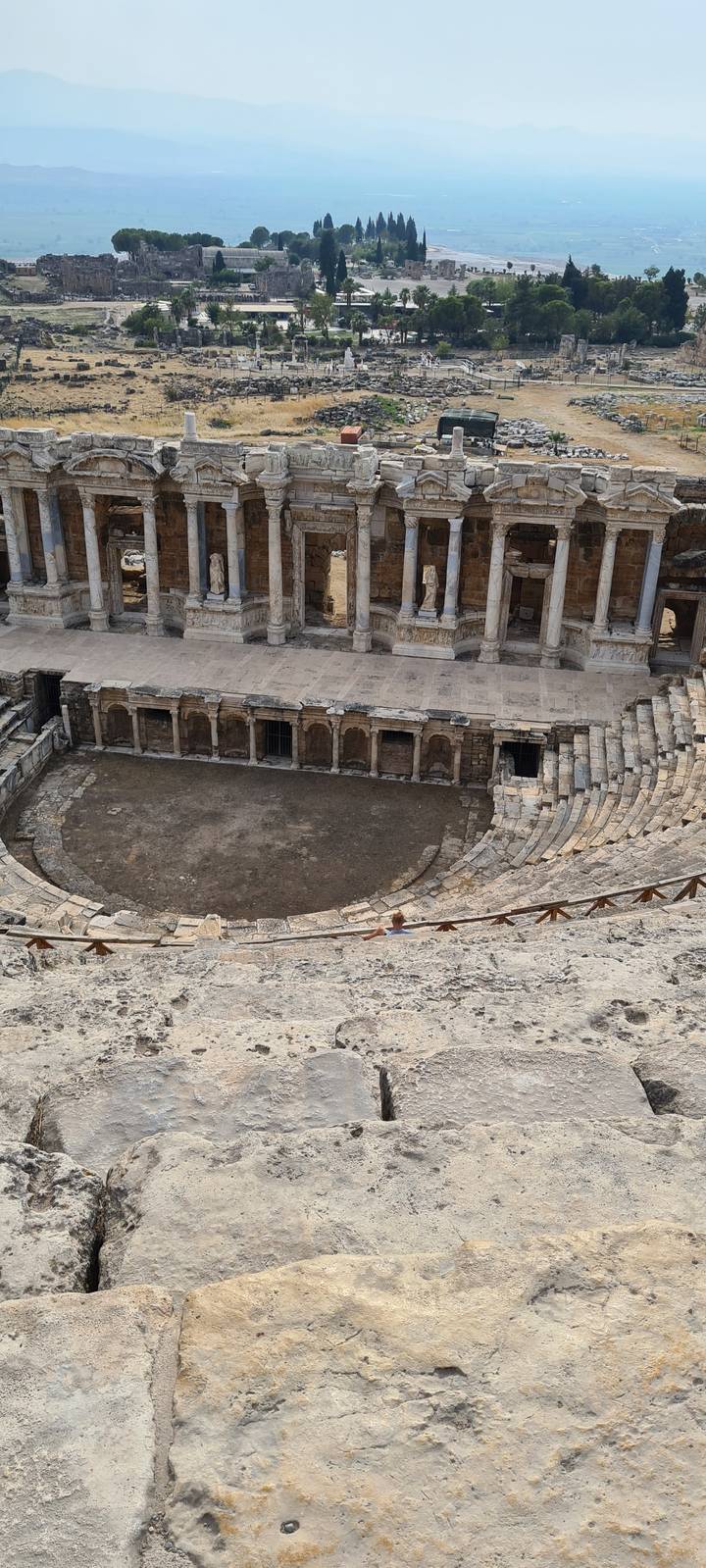 Ancient amphitheater ruins with a view of the surrounding area.