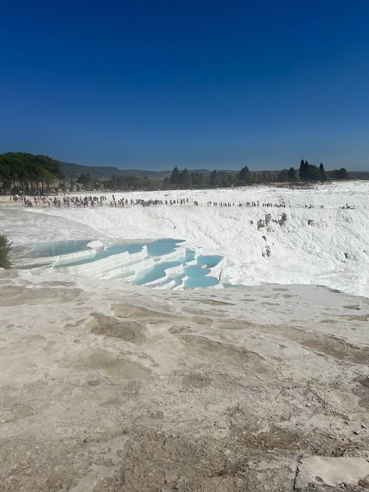 Natural thermal terraces with blue mineral-rich water