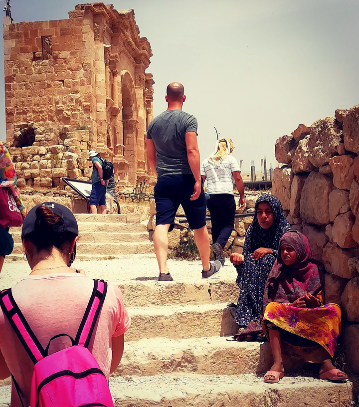 Multiple people at an ancient ruins site.